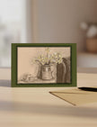 April Still Life Greetings Card on table with a pen and envelope