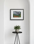 Summer Storm Near Witley Court Framed Art Print in an alcove above a small table with a potted plant on