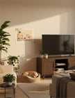 Chance the Staffordshire Bull Terrier Art Print on the wall next to a tv in a living room with a dog asleep in a basket