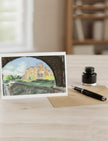 Biddulph Grange Garden Greetings Card a pastel drawing by Emily Tellwright on a table with fountain pen and ink