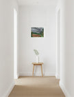 Summer Storm Near Witley Court Art print on wall above a table with a plant on