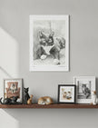 Edith the Cat Art Print on a wall above a shelf with cat photos and ornaments