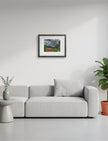 Summer Storm Near Witley Court Framed Art Print above a grey sofa with plants