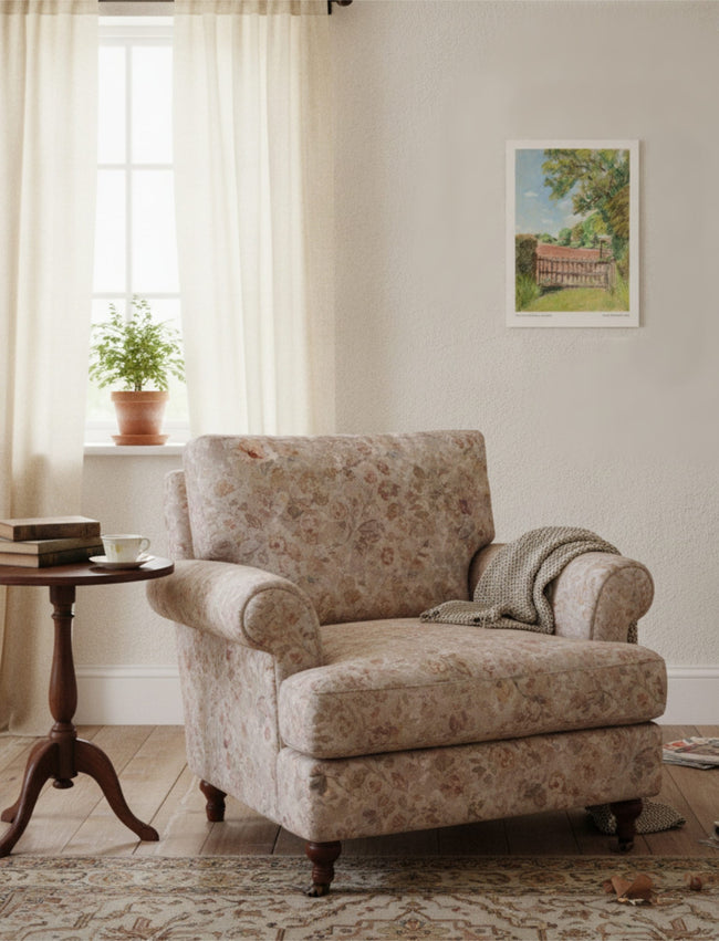 The view from St Mary's Kempley Art Print on the wall a comfortable chair next to a small side table with a plant in the background