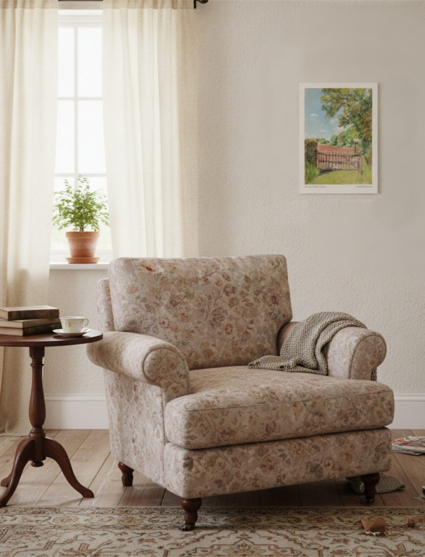 The view from St Mary's Kempley Art Print on the wall a comfortable chair next to a small side table with a plant in the background