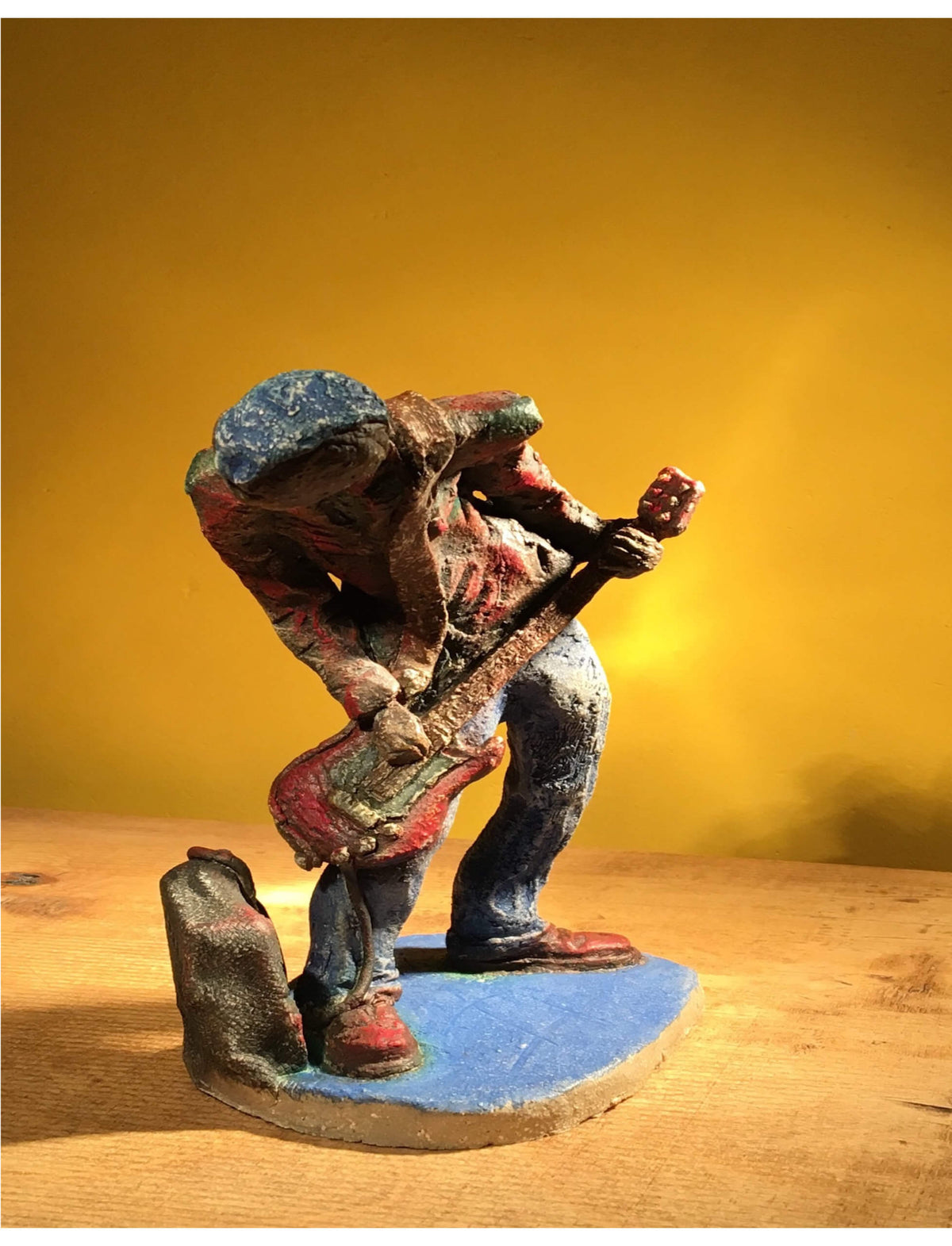 Ceramic sculpture of a punk guitarist