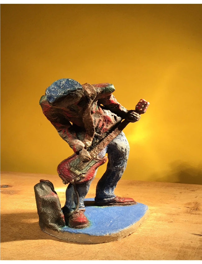 Ceramic sculpture of a punk guitarist