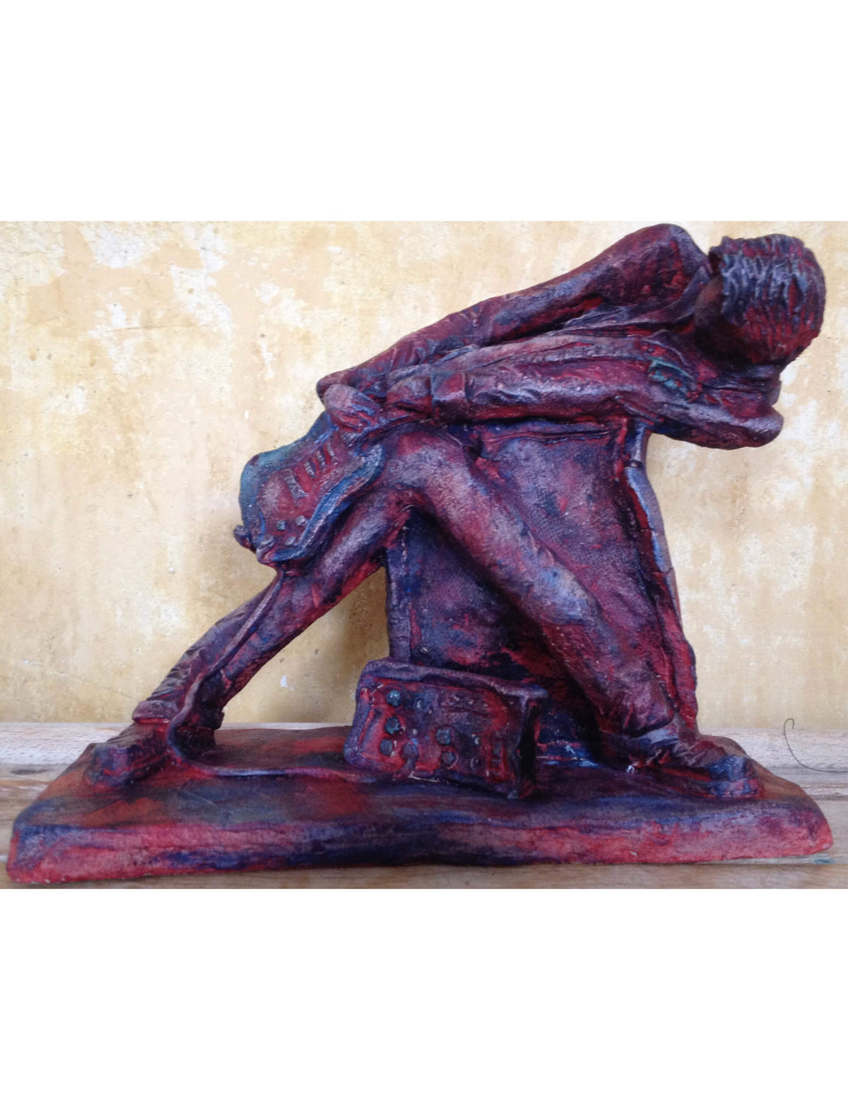 Ceramic sculpture of a rock guitarist painted red