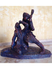 Ceramic sculpture of a singer and guitarist painted red.