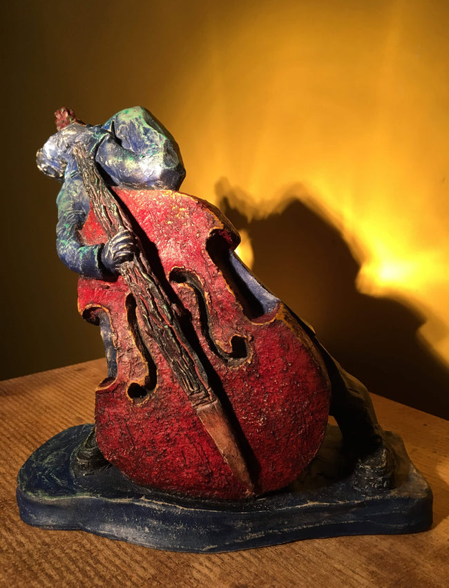 Ceramic sculpture of rockabilly bass player.