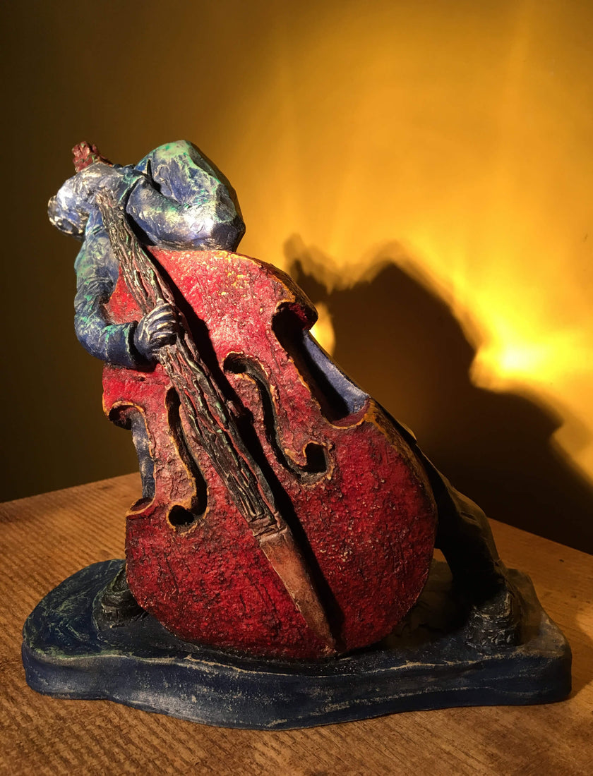 Ceramic sculpture of rockabilly bass player.