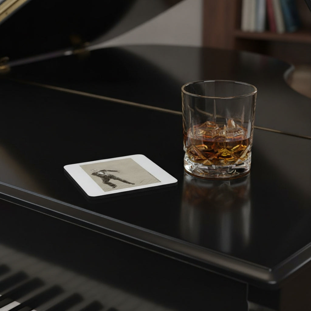 A clear square coaster with rounded corners sits on the glossy black surface of a grand piano next to a glass of whiskey with ice.