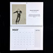 A spiral-bound May calendar page from 'Fantastic Fred Actaire No 3' by Emily tellwright, featuring a sketch of a dancer and a calendar grid with a notes section, photographed against a black background.