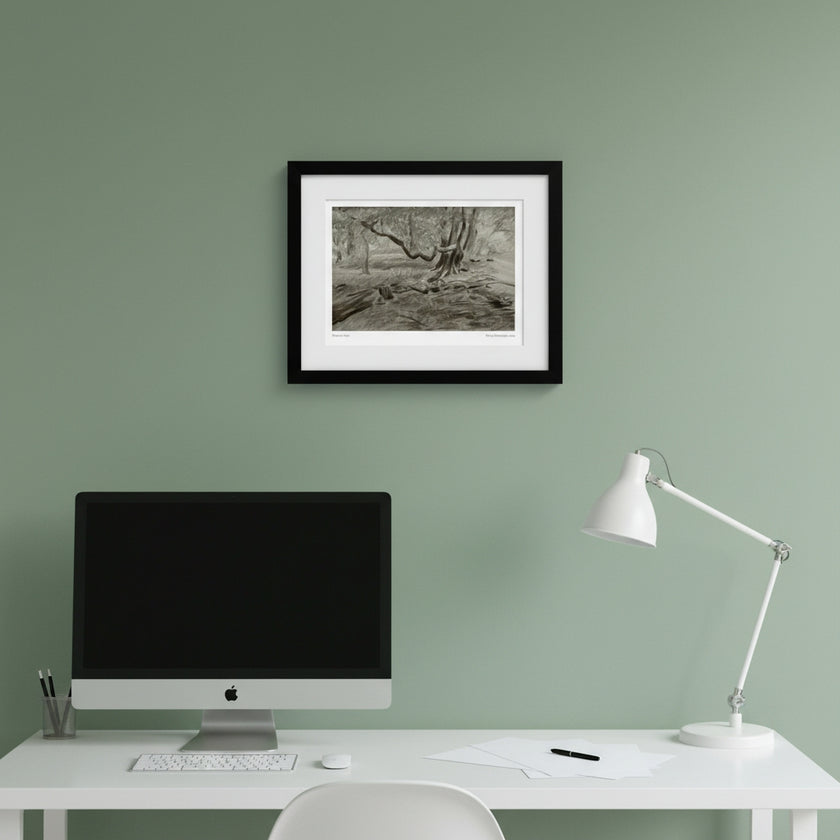 A framed black and white landscape art print hangs on a light gray wall above a dark wood sideboard with silver goblets, a glass decanter, and a bowl of fruit.