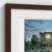 A close-up of a framed art print showing a painted forest scene with green and yellow foliage, a white mat, and a dark brown wooden frame against a white wall.