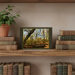 A forest landscape greetings card is displayed on a rustic wooden shelf, flanked by stacks of vintage books and a potted ivy plant against a neutral beige wall.