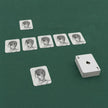 Grey day playing cards laid out on a green baize table