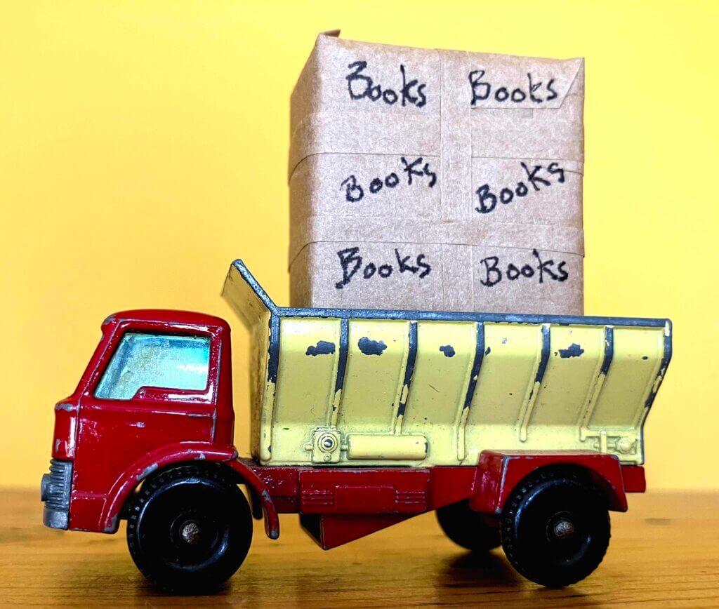 An old fashioned lorry carrying parcels of books: you won't buy Castle Sefton Press books like this!