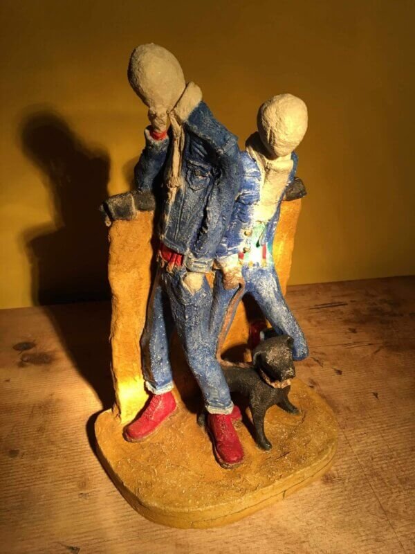 Ceramic sculpture of two skinheads with a dog