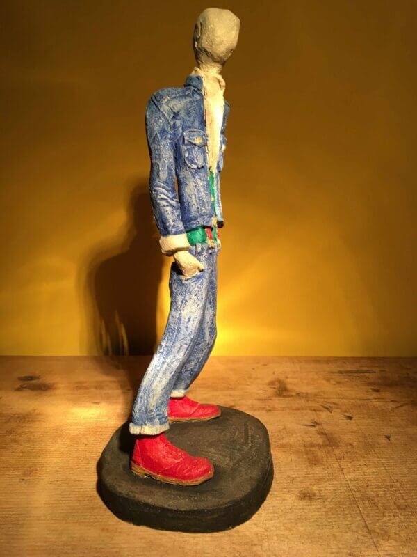 Ceramic sculpture of skinhead in green shirt