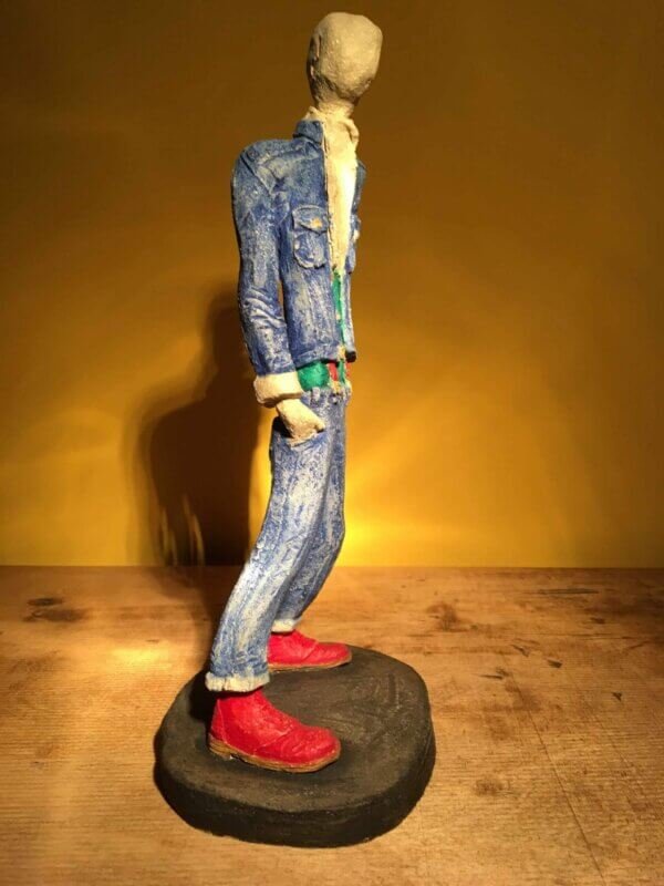 Ceramic sculpture of skinhead in green shirt