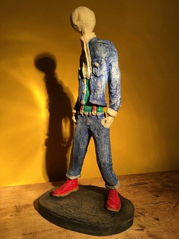 Ceramic sculpture of skinhead in green shirt