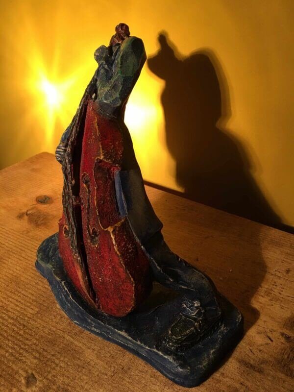 Ceramic sculpture of rockabilly bass player.