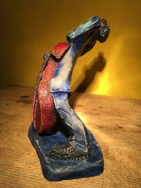 Ceramic sculpture of rockabilly bass player.