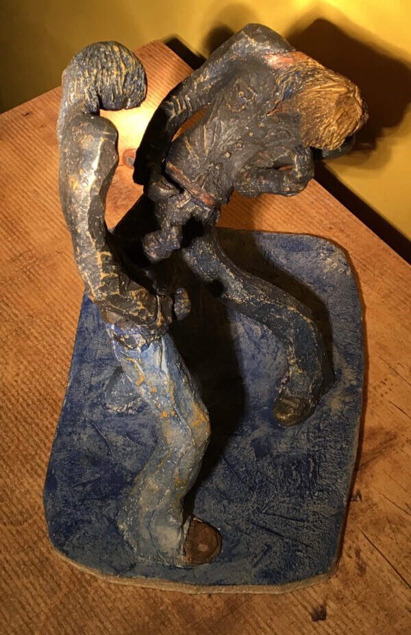 Ceramic sculpture of two air guitarists duelling.