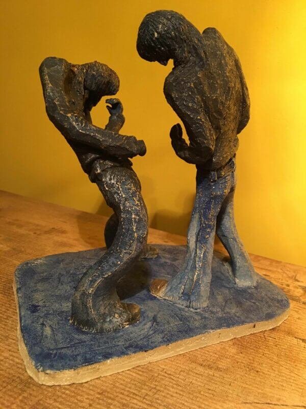 Ceramic sculpture of two air guitarists duelling.