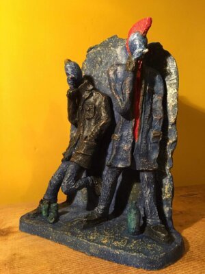 Ceramic sculpture of two punks leaning on a wall smoking.