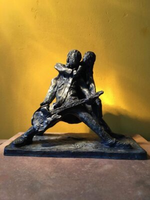 Ceramic sculpture of a rock singer and guitarist