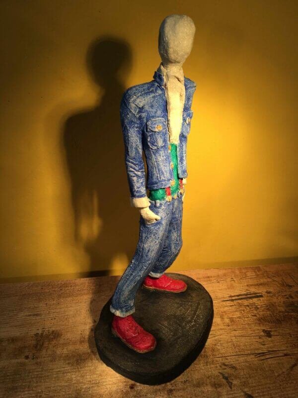 Ceramic sculpture of skinhead in green shirt