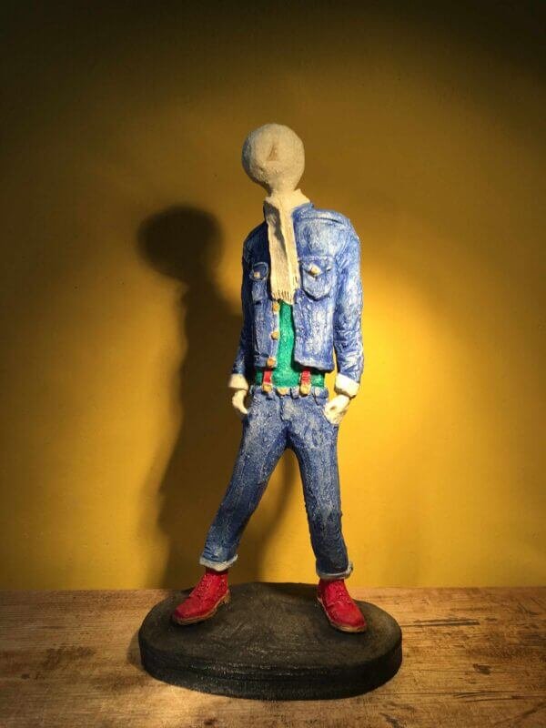 Ceramic sculpture of skinhead in green shirt