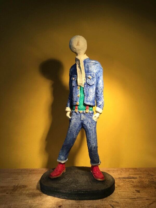 Ceramic sculpture of skinhead in green shirt