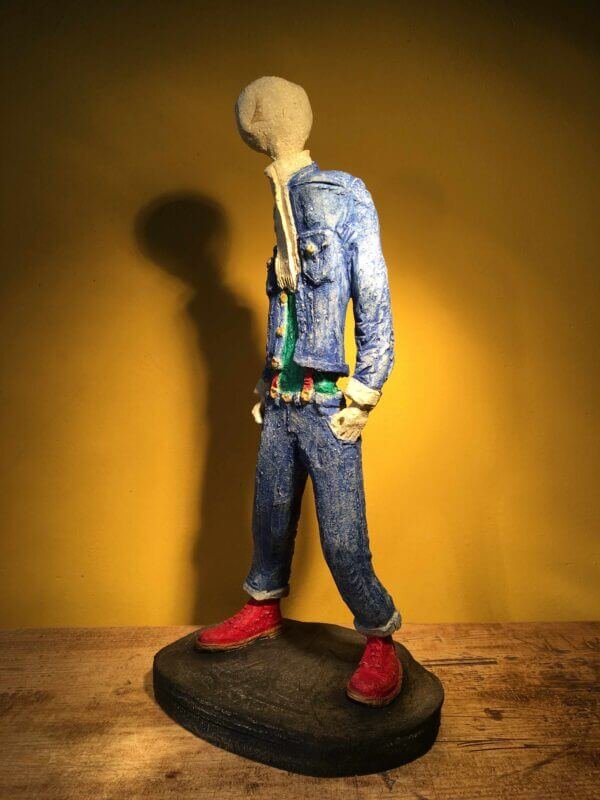 Ceramic sculpture of skinhead in green shirt