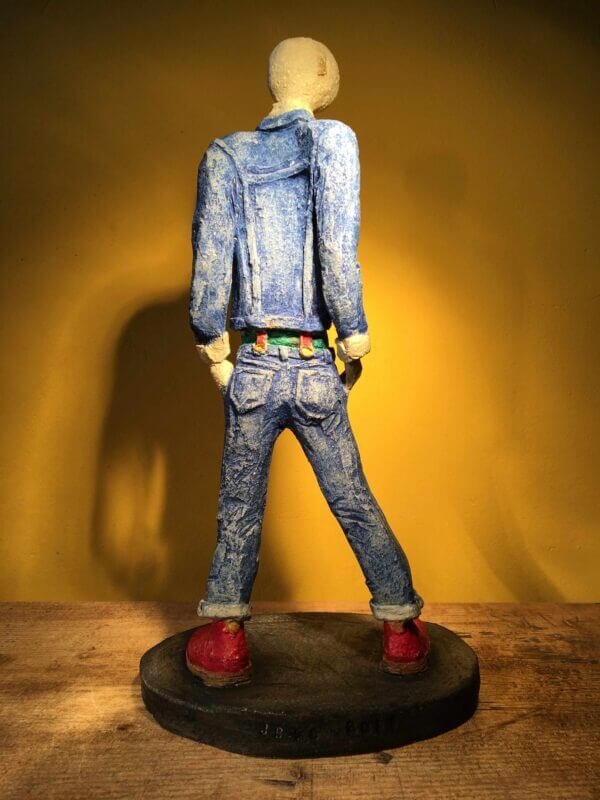 Ceramic sculpture of skinhead in green shirt