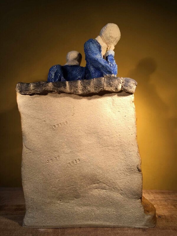 Ceramic sculpture of two skinheads with a dog