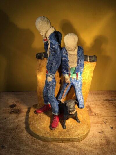 Ceramic sculpture of two skinheads with a dog