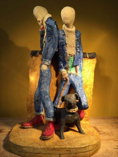Ceramic sculpture of two skinheads with a dog
