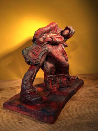 Ceramic sculpture of a rock guitarist painted red
