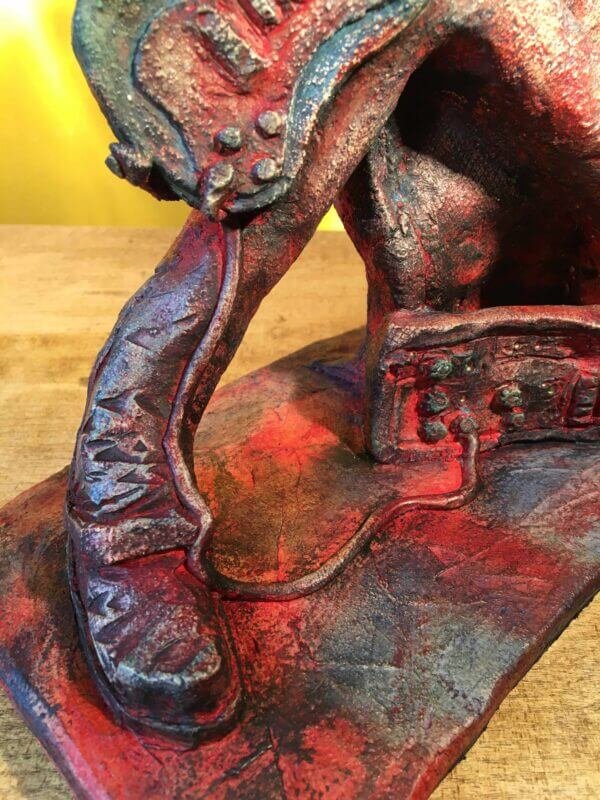 Ceramic sculpture of a rock guitarist painted red