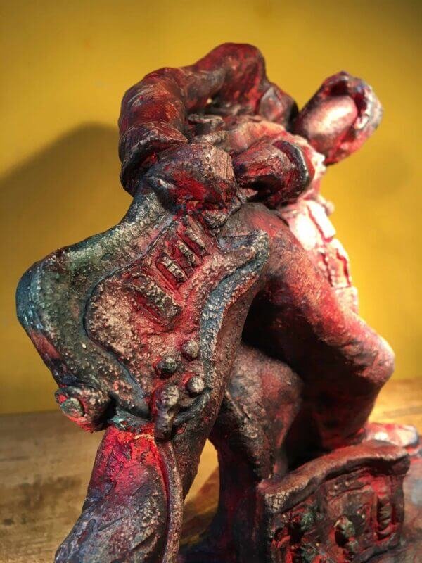 Ceramic sculpture of a rock guitarist painted red