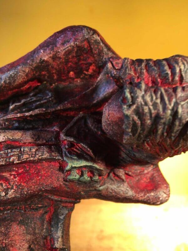 Ceramic sculpture of a rock guitarist painted red