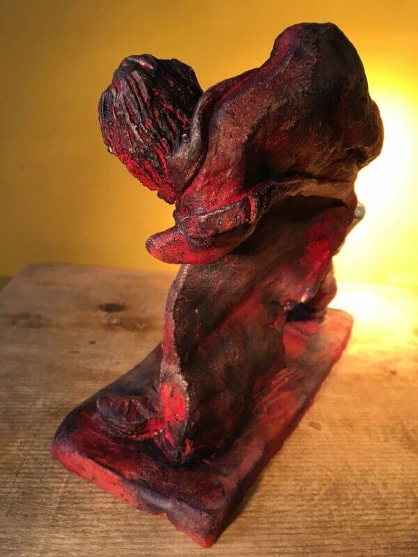 Ceramic sculpture of a rock guitarist painted red