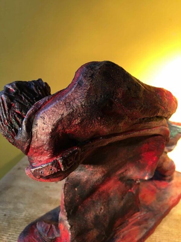 Ceramic sculpture of a rock guitarist painted red