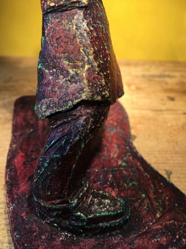 Ceramic sculpture of a rockabilly guitarist painted red.