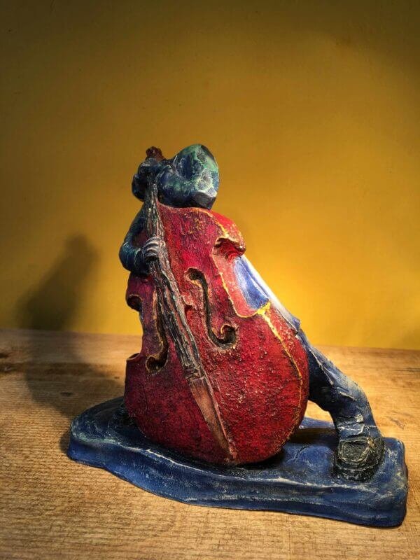 Ceramic sculpture of rockabilly bass player.