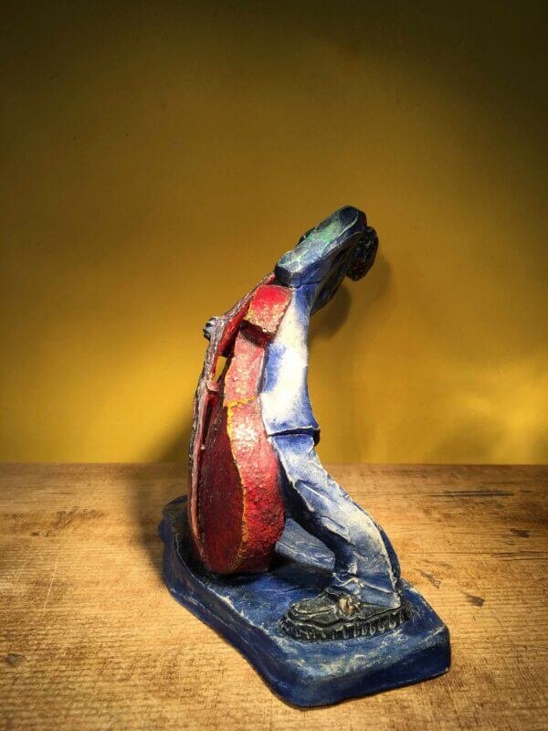 Ceramic sculpture of rockabilly bass player.