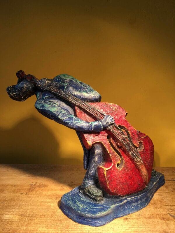 Ceramic sculpture of rockabilly bass player.